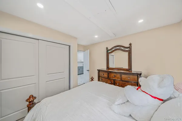 a bedroom with a bed and a dresser