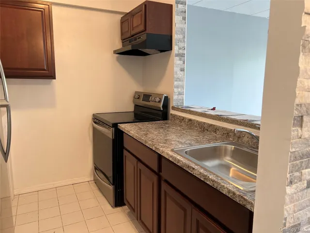 a kitchen with a sink and a refrigerator