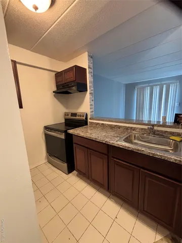 a kitchen with stainless steel appliances granite countertop a sink and cabinets