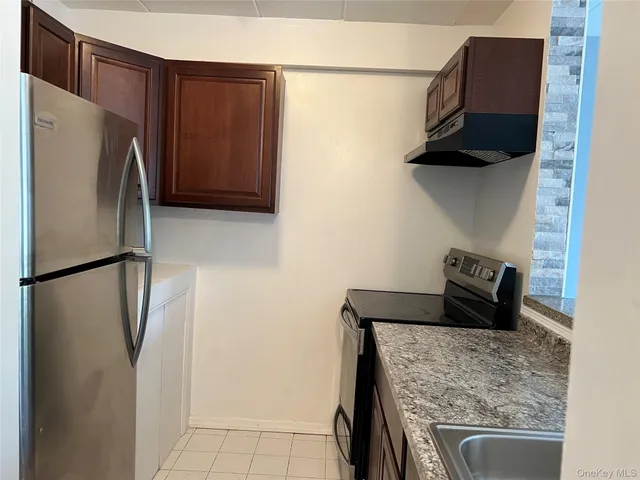 a kitchen with a refrigerator and a stove