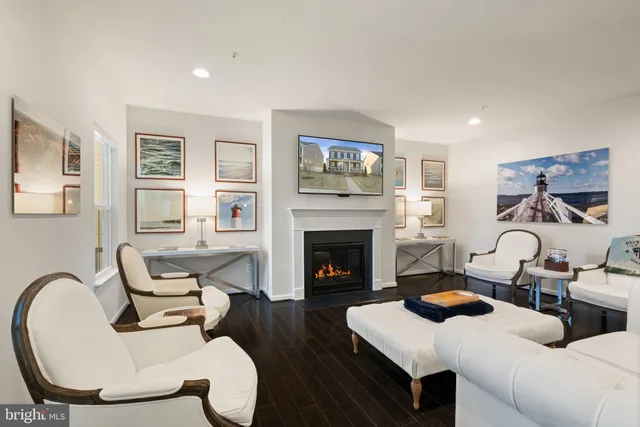 a view of a dining room with furniture a rug and wooden floor
