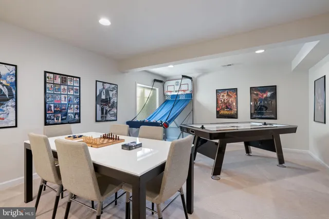 a dining room with furniture a chandelier and wooden floor