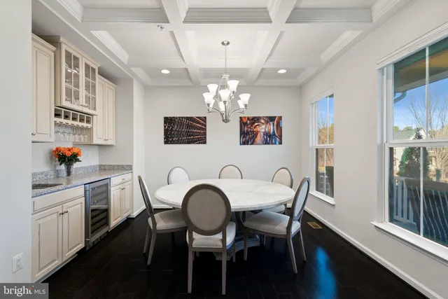 a view of a dining room with a table and chairs