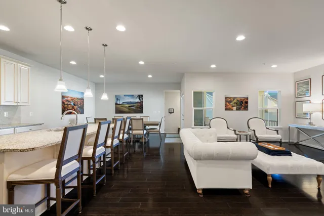 a large kitchen with stainless steel appliances granite countertop a lot of counter space a sink and a stove