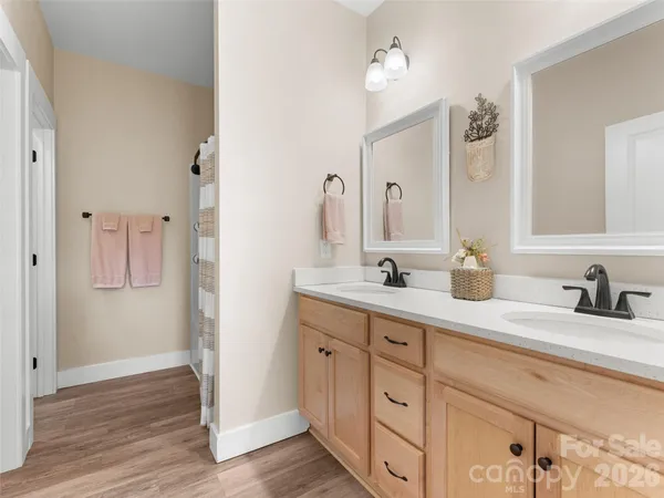 a bathroom with double sink and a mirror