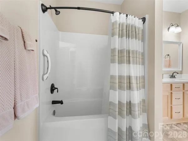a bathroom with a shower and a tub