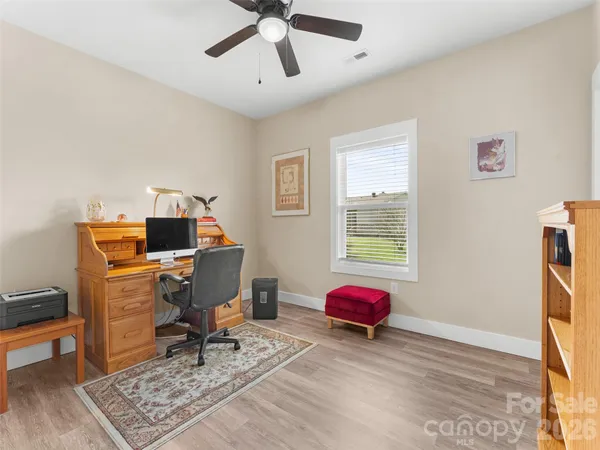 a view of a workspace with lounge chair and a window