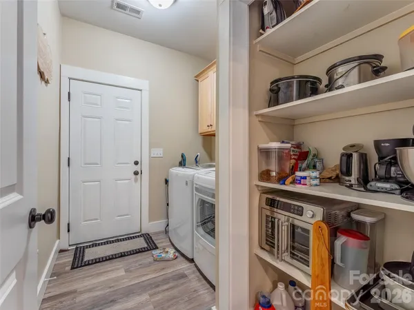 a kitchen with refrigerator and cabinets