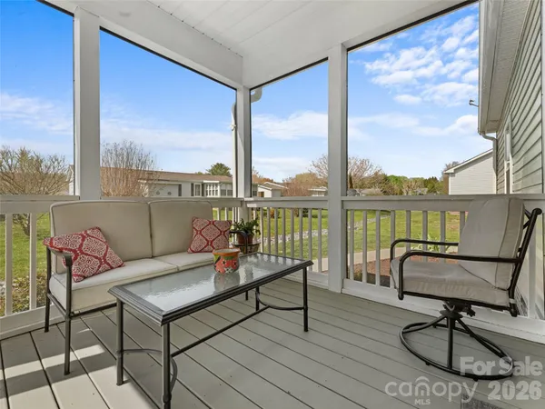 a living room with furniture city view and large windows