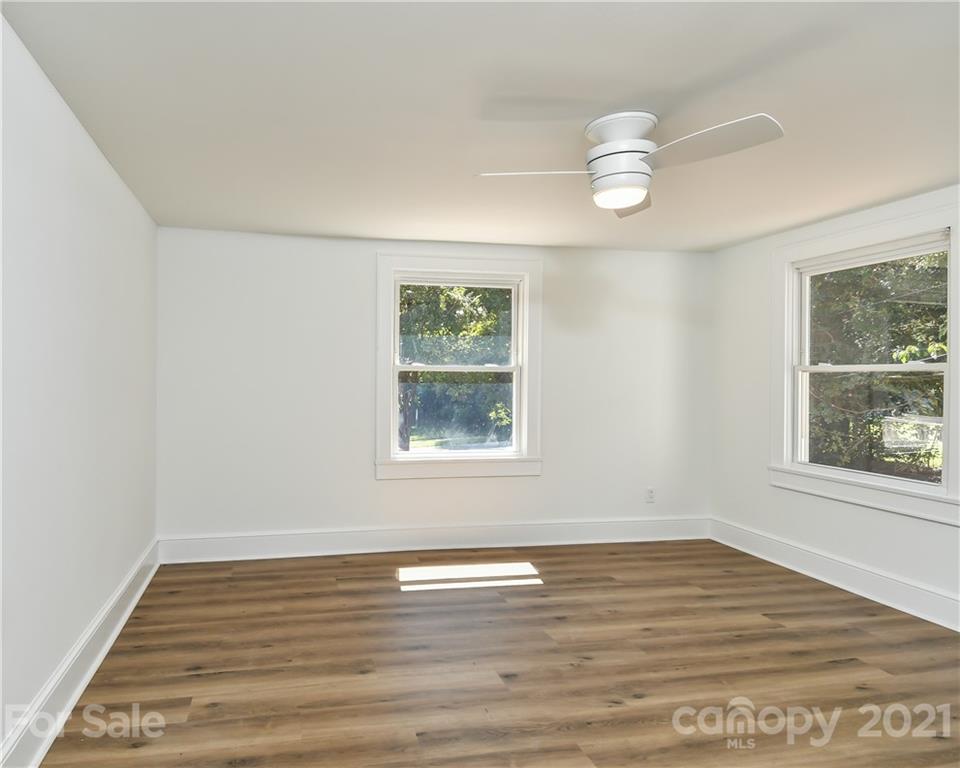 1215 Summerville Road Charlotte, NC 28214 - Photo 11 of 25 a view of an empty room with wooden floor and a window