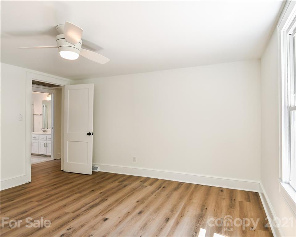 1215 Summerville Road Charlotte, NC 28214 - Photo 12 of 25 an empty room with wooden floor and windows