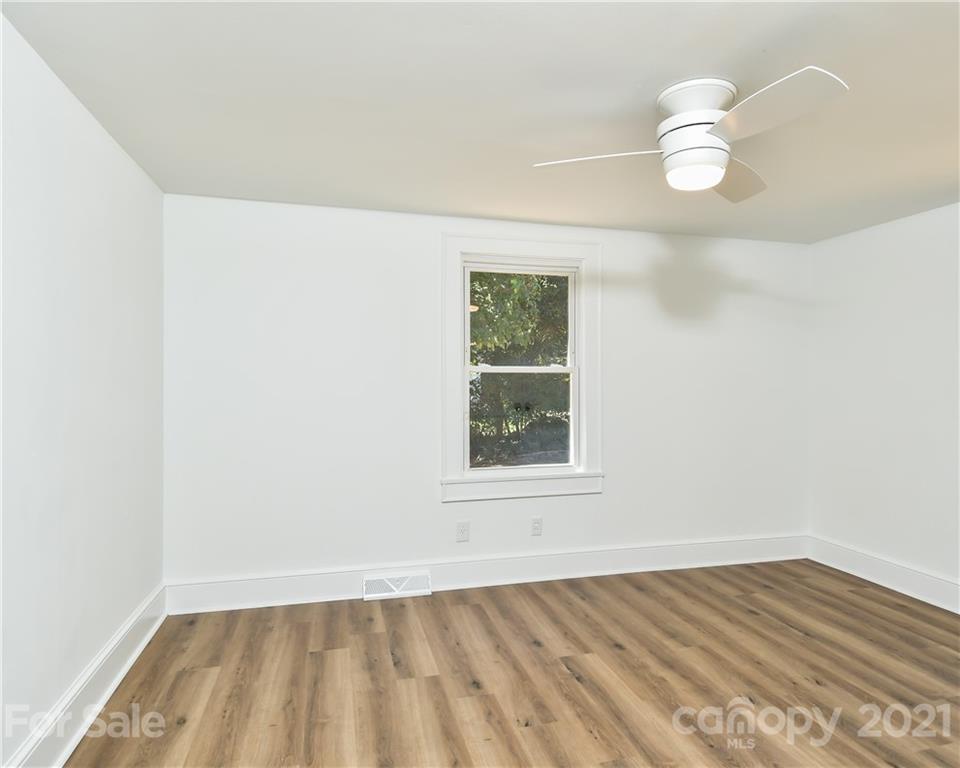 1215 Summerville Road Charlotte, NC 28214 - Photo 13 of 25 an empty room with wooden floor and windows