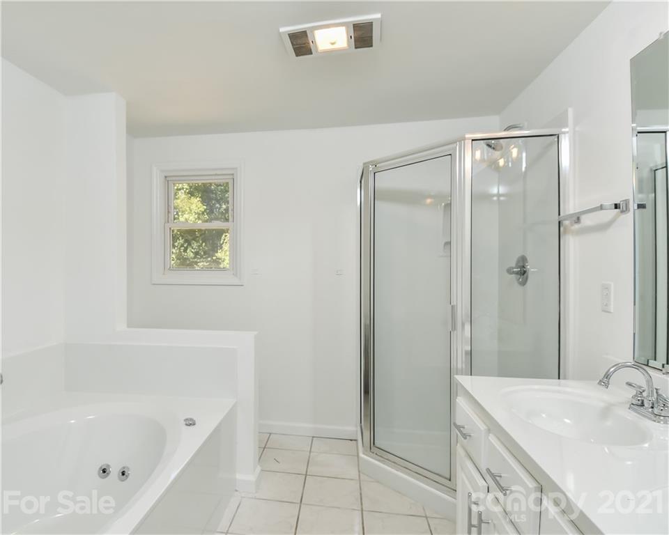 1215 Summerville Road Charlotte, NC 28214 - Photo 15 of 25 a bathroom with a tub sink and a mirror