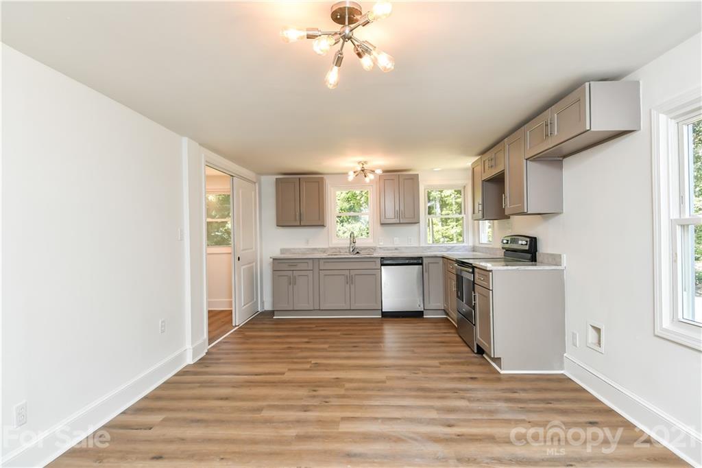 1215 Summerville Road Charlotte, NC 28214 - Photo 19 of 25 a kitchen with a white cabinets and window