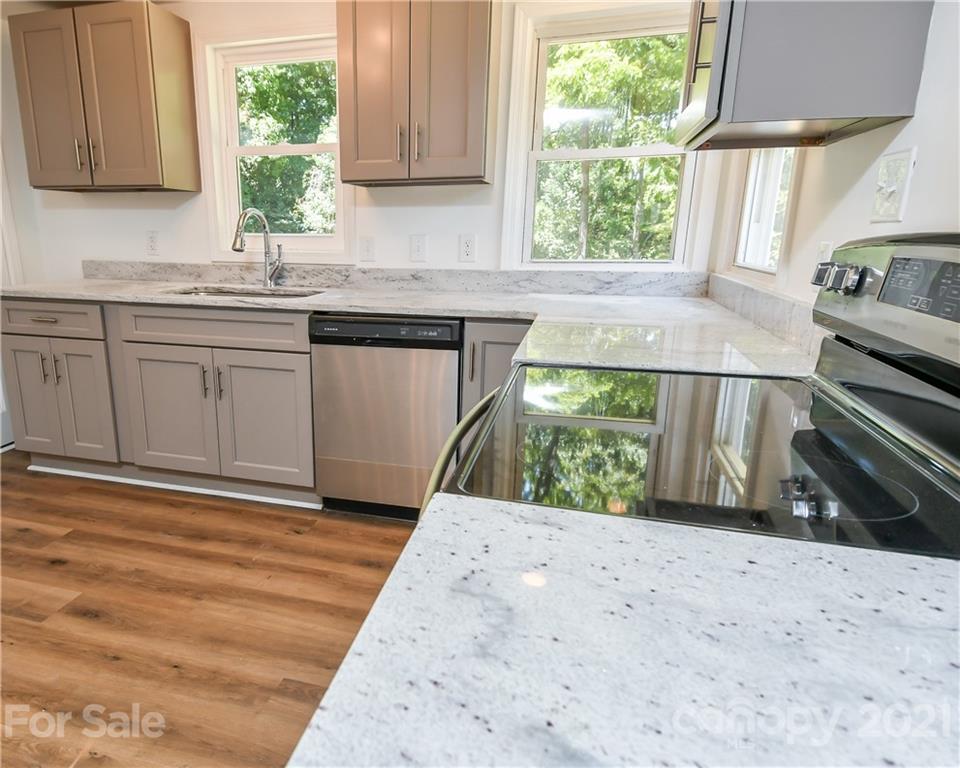1215 Summerville Road Charlotte, NC 28214 - Photo 21 of 25 a kitchen with a stove a sink and a window
