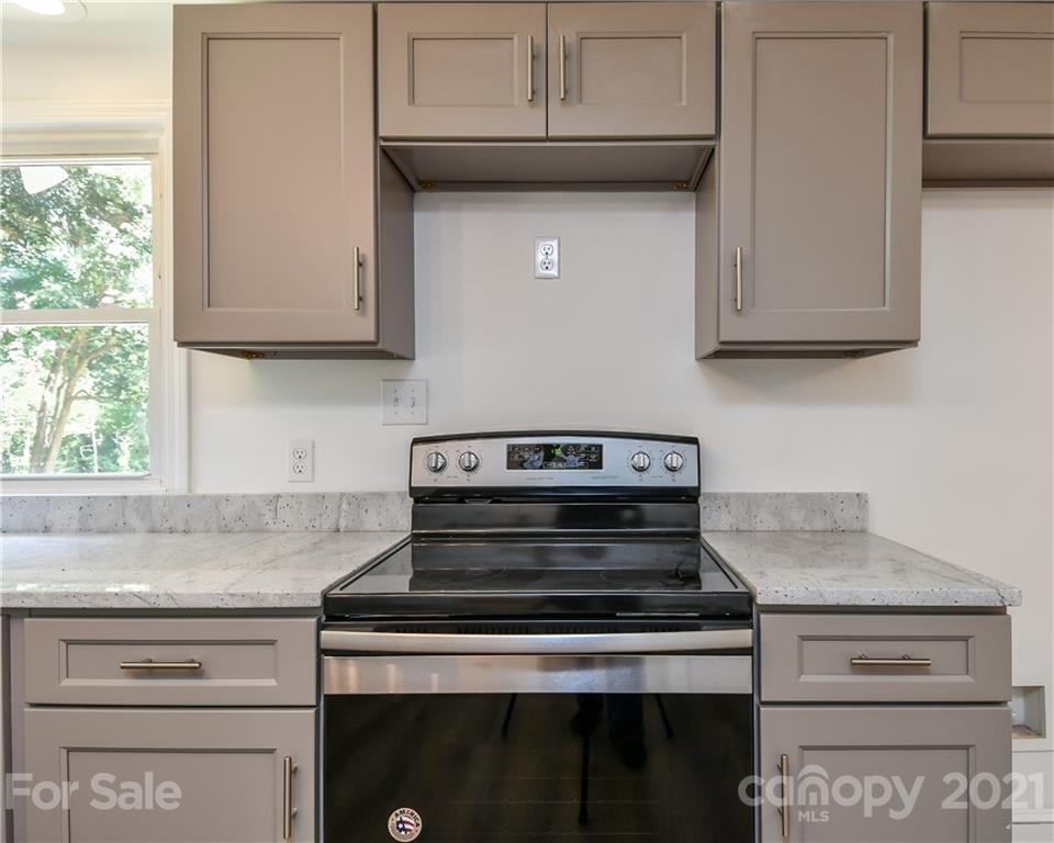 1215 Summerville Road Charlotte, NC 28214 - Photo 22 of 25 a stove top oven sitting inside of a kitchen