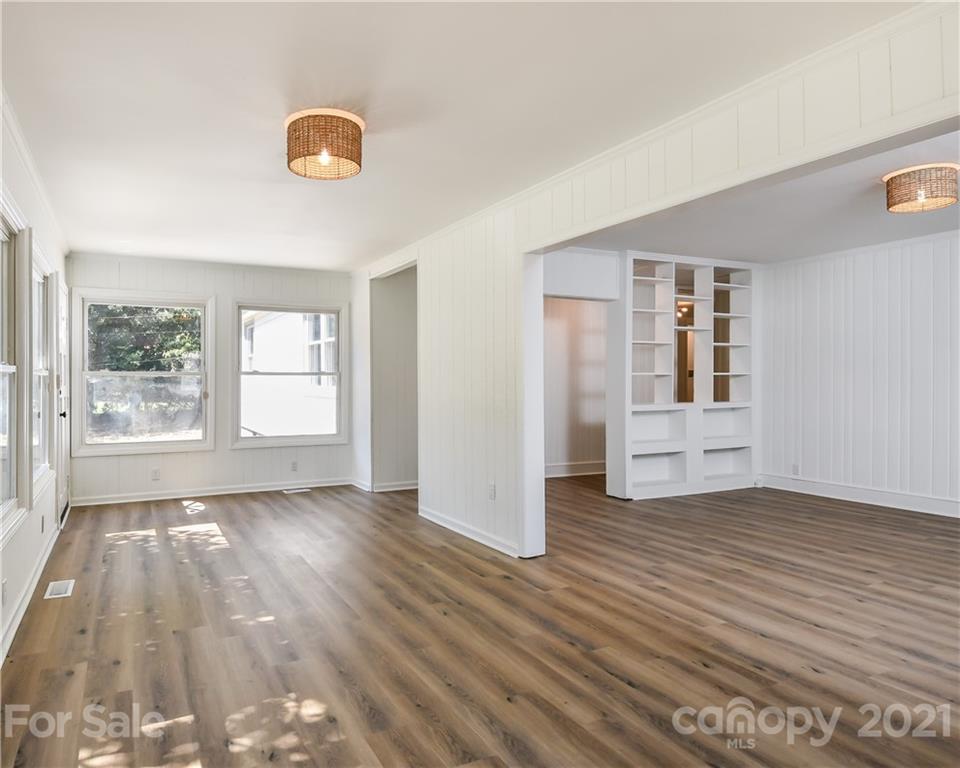 1215 Summerville Road Charlotte, NC 28214 - Photo 5 of 25 a view of an empty room with wooden floor and a window