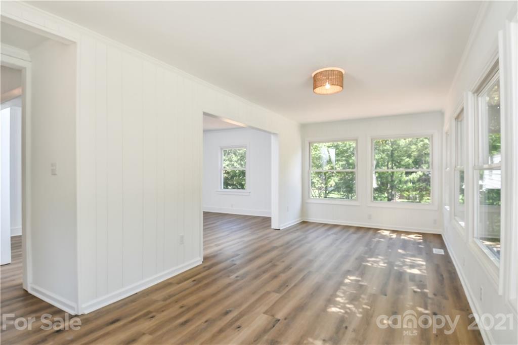 1215 Summerville Road Charlotte, NC 28214 - Photo 6 of 25 an empty room with wooden floor and windows