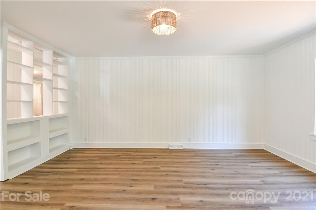 1215 Summerville Road Charlotte, NC 28214 - Photo 7 of 25 a view of an empty room with wooden floor and window