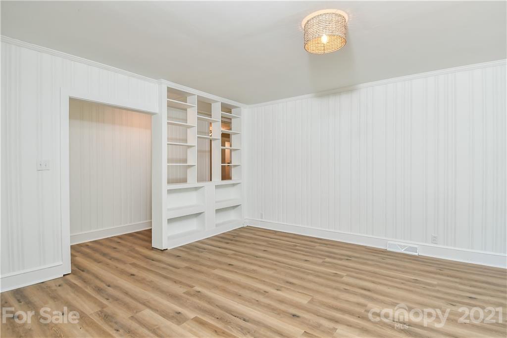 1215 Summerville Road Charlotte, NC 28214 - Photo 8 of 25 a view of empty room with wooden floor and fan