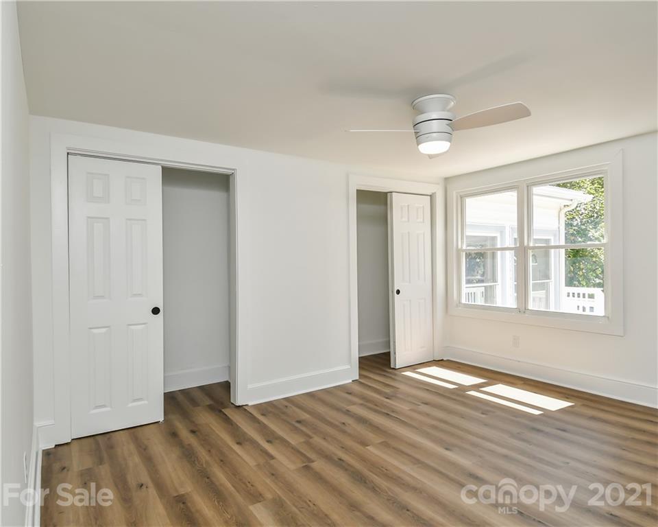 1215 Summerville Road Charlotte, NC 28214 - Photo 9 of 25 a view of an empty room with wooden floor and a window