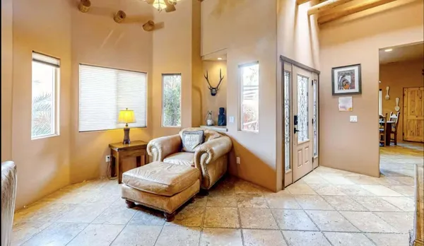a living room with furniture and a floor to ceiling window