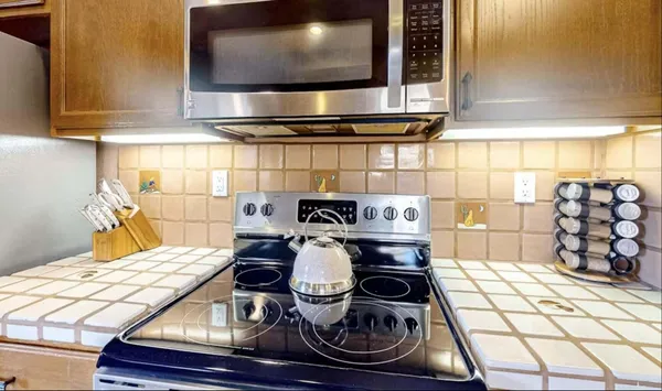 a kitchen with a stove and cabinets