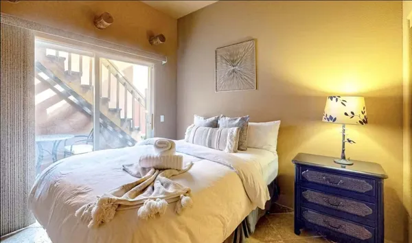 a bed sitting in a bedroom next to a window