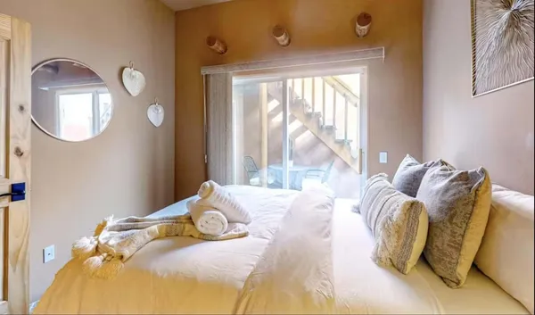 a bedroom with bed and a large mirror