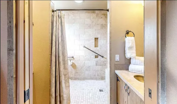a bathroom with a tub and shower