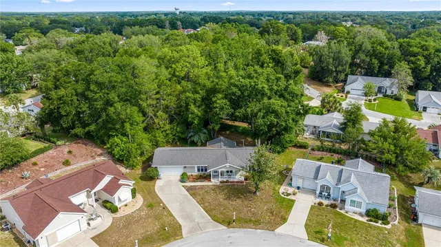 an aerial view of a house with a yard and lake view