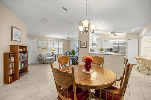 a view of a dining room with furniture and a chandelier