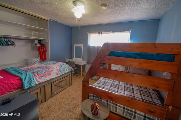 a bedroom with bed and wooden floor