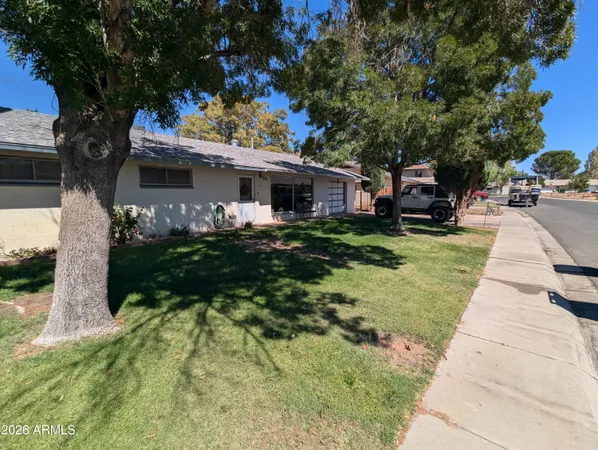 a front view of house with yard and green space