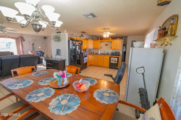 a view of a dining room with furniture and a chandelier