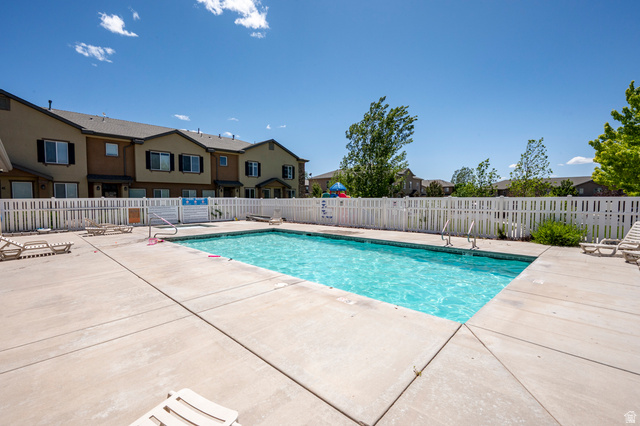 1177 Northfield Road, Unit 26 Cedar City, UT 84721 - Photo 42 of 45 Rectangular swimming pool surrounded by a concrete deck and white picket fencing