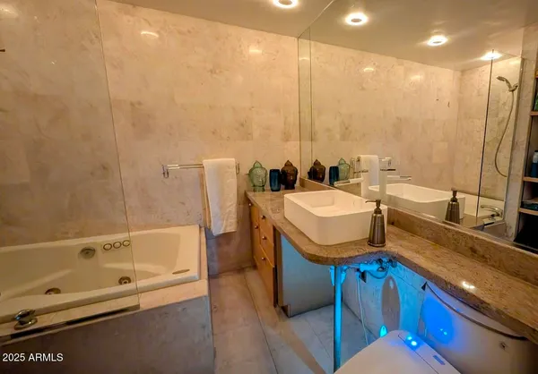 a bathroom with a sink a tub and a mirror