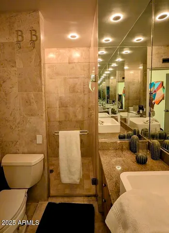 a bathroom with a toilet and a shower