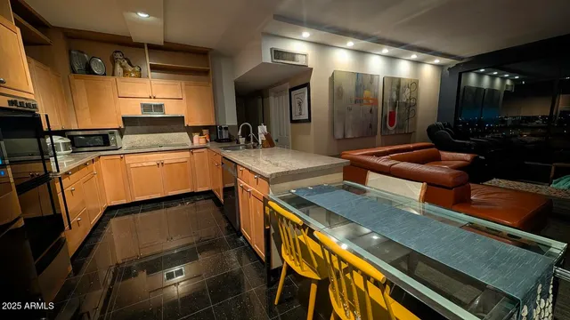 a kitchen with stainless steel appliances granite countertop a sink and cabinets