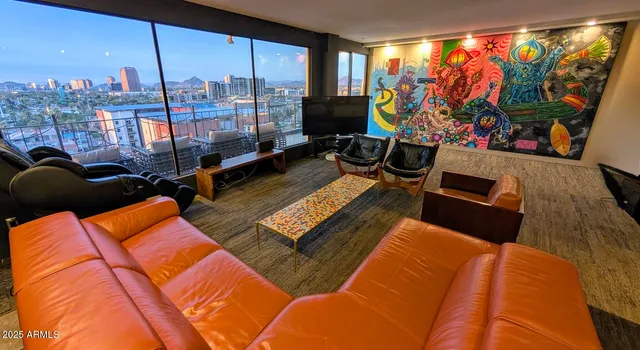 a living room with furniture a flat screen tv and a large window