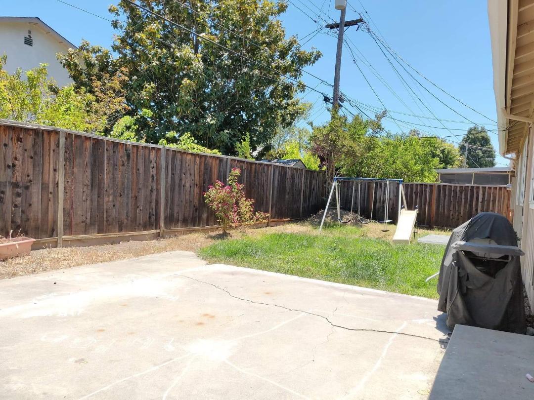 1482 Fields Drive San Jose, CA 95129 - Photo 15 of 15 a view of backyard with wooden fence and trees in the background