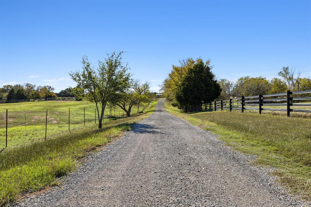 2212 Spring Hill Road Aubrey, TX 76227 - Photo 29 of 36 a view of road with grass and trees