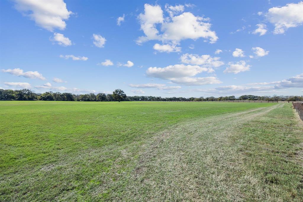 2212 Spring Hill Road Aubrey, TX 76227 - Photo 6 of 36 a view of a big yard with lots of green space and mountain view