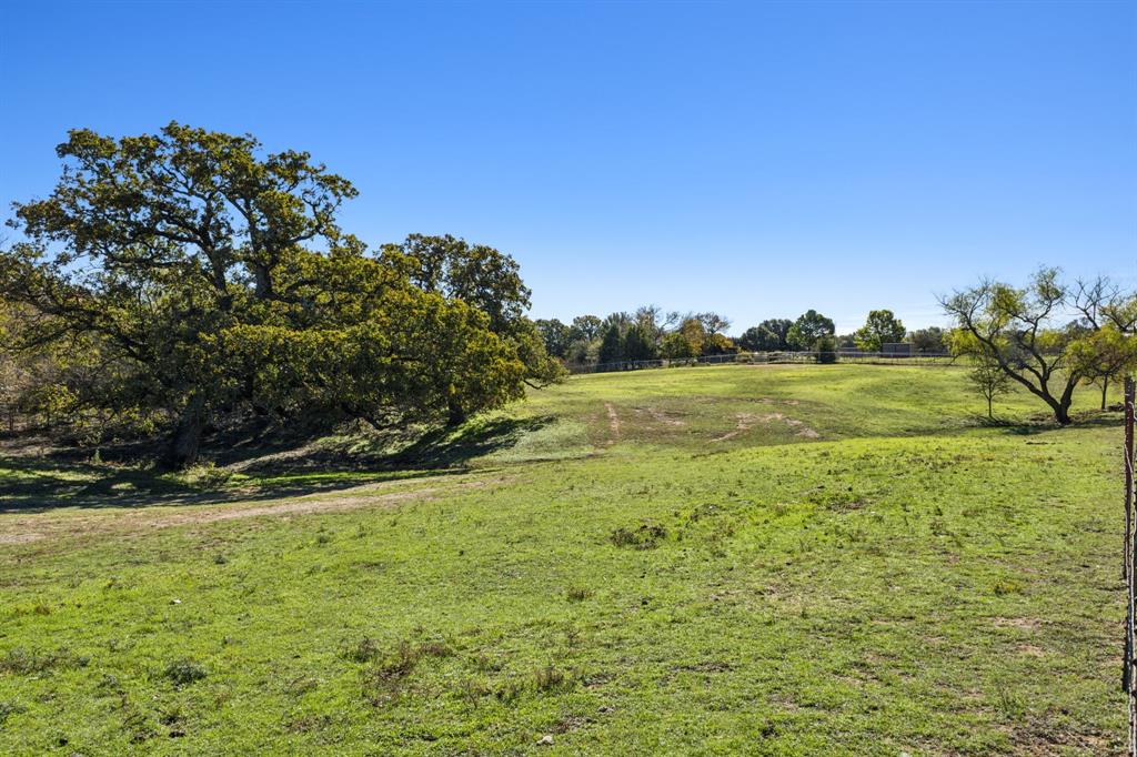 2212 Spring Hill Road Aubrey, TX 76227 - Photo 10 of 36 a view of a field with an trees