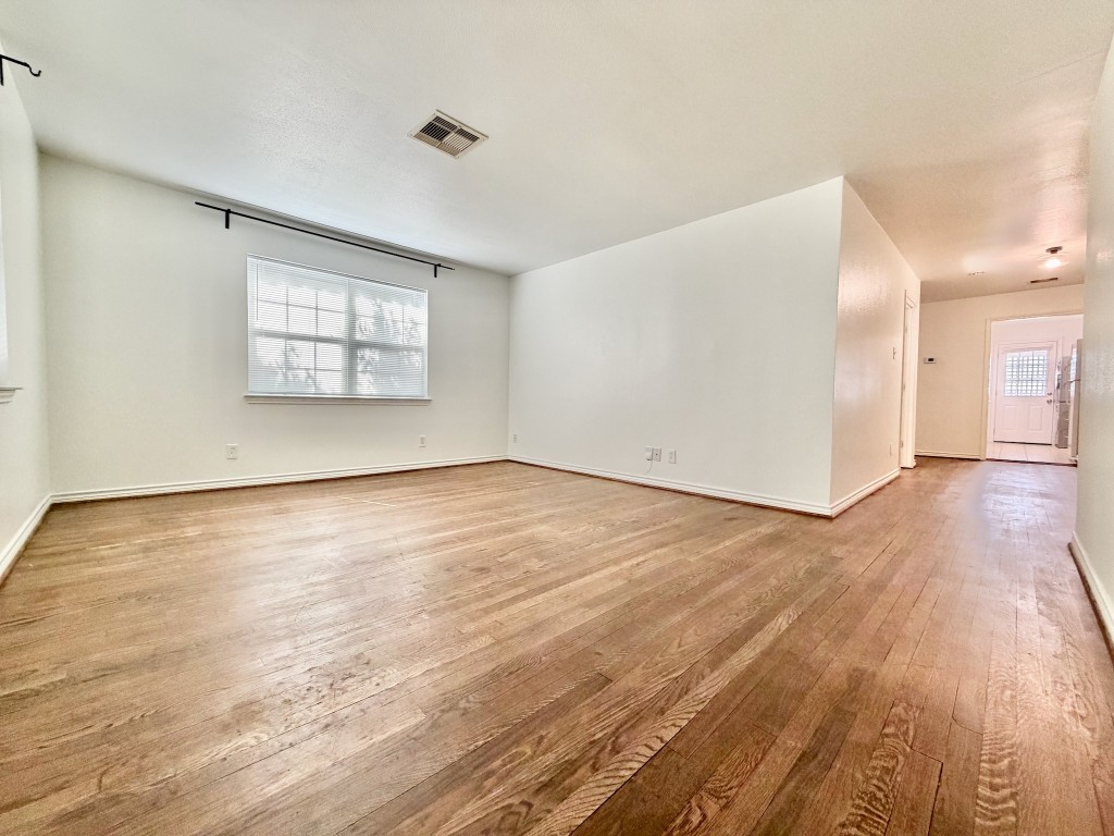 2126 Banks Street, Unit 3 Houston, TX 77098 - Photo 12 of 41 an empty room with wooden floor and windows