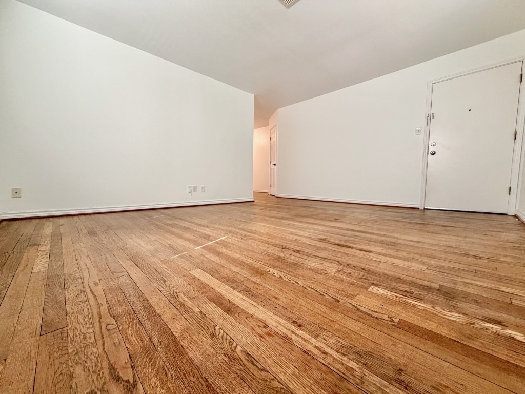 2126 Banks Street, Unit 3 Houston, TX 77098 - Photo 14 of 41 a view of an empty room with wooden floor