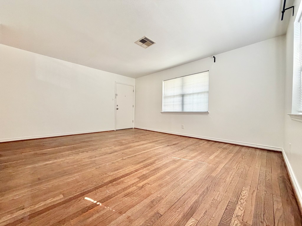 2126 Banks Street, Unit 3 Houston, TX 77098 - Photo 16 of 41 an empty room with wooden floor and windows