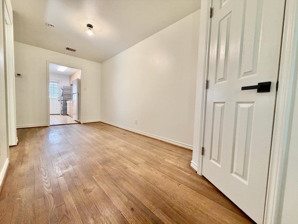 2126 Banks Street, Unit 3 Houston, TX 77098 - Photo 18 of 41 an empty room with wooden floor and windows