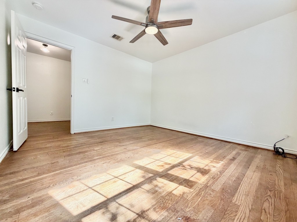 2126 Banks Street, Unit 3 Houston, TX 77098 - Photo 20 of 41 a view of a room with wooden floor and a ceiling fan