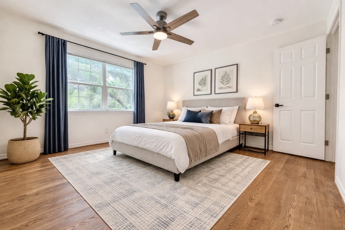 2126 Banks Street, Unit 3 Houston, TX 77098 - Photo 21 of 41 a bedroom with a large bed potted plant and a window